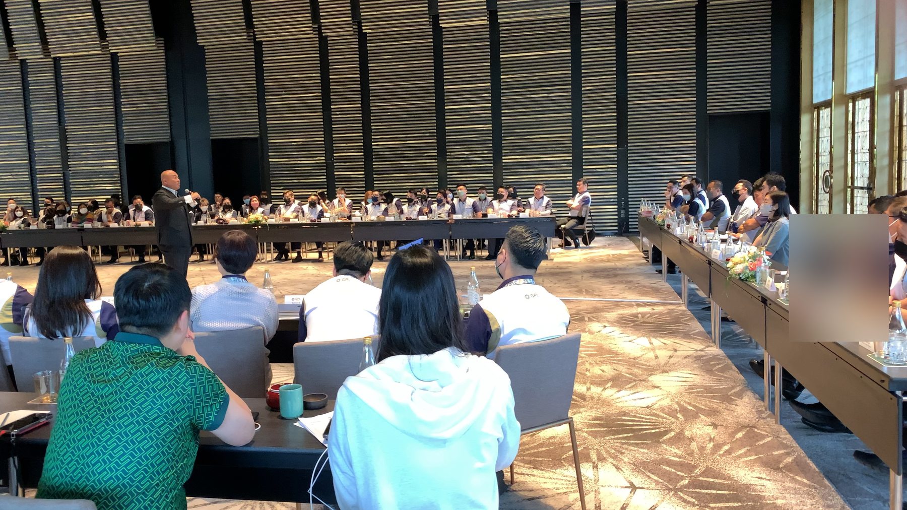 Marcus Lim commanding the room — both sides of the U-table engaged